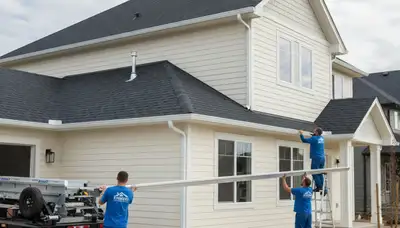 Seamless gutter installation on Tulsa OK home by Next Level Exteriors vinyl siding experts